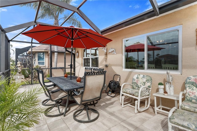 view of patio featuring glass enclosure