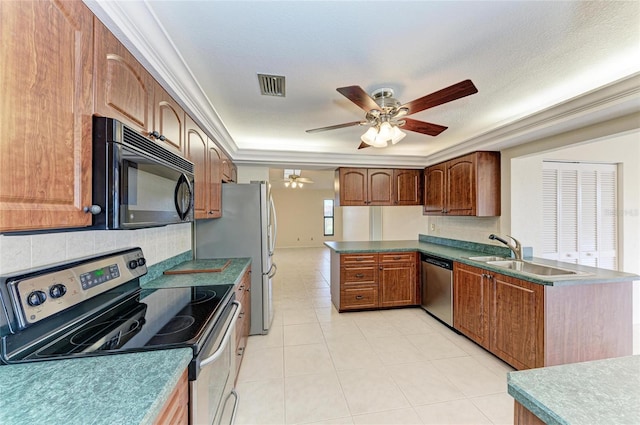 kitchen with a raised ceiling, sink, decorative backsplash, ceiling fan, and stainless steel appliances