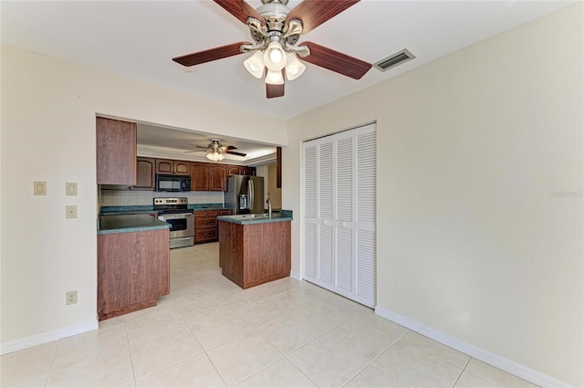 kitchen with light tile patterned floors, appliances with stainless steel finishes, kitchen peninsula, ceiling fan, and backsplash