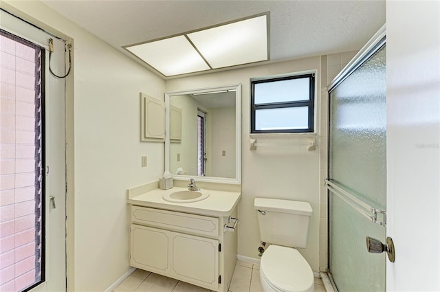 bathroom featuring tile patterned flooring, vanity, an enclosed shower, a textured ceiling, and toilet