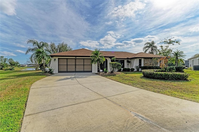 ranch-style house featuring a garage, central AC, and a front lawn