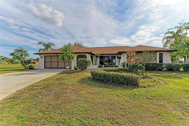 view of front of property featuring a garage and a front yard