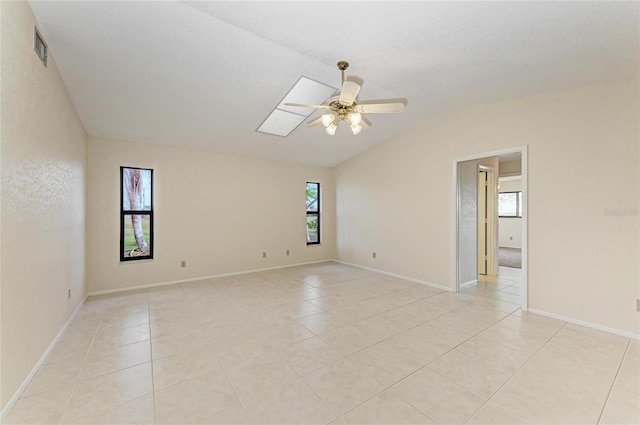 unfurnished room featuring vaulted ceiling, visible vents, a ceiling fan, and light tile patterned flooring