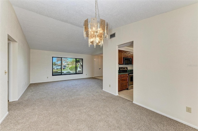 empty room featuring light carpet, a textured ceiling, baseboards, visible vents, and a chandelier