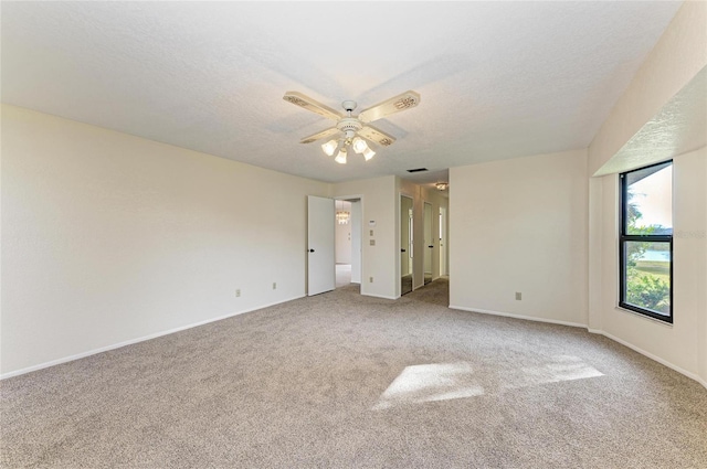 unfurnished bedroom featuring a textured ceiling, carpet flooring, and baseboards