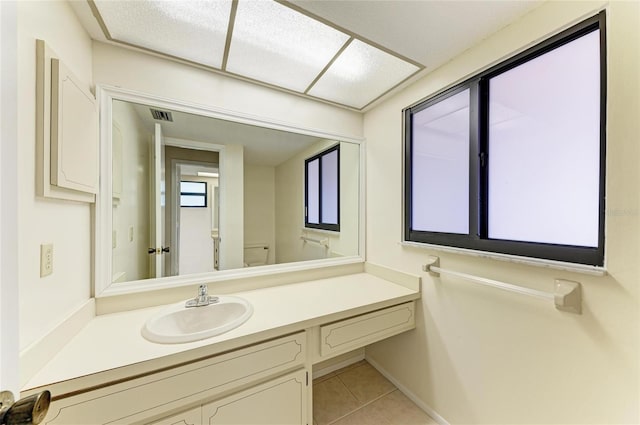 bathroom with tile patterned floors, visible vents, and vanity