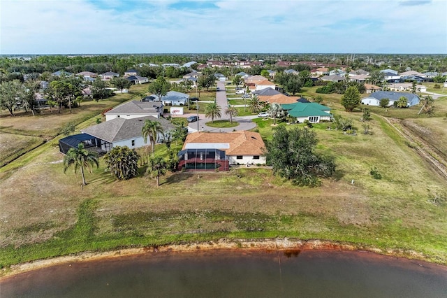 birds eye view of property with a water view and a residential view