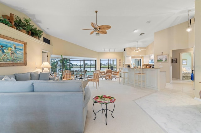 living room featuring high vaulted ceiling and ceiling fan with notable chandelier