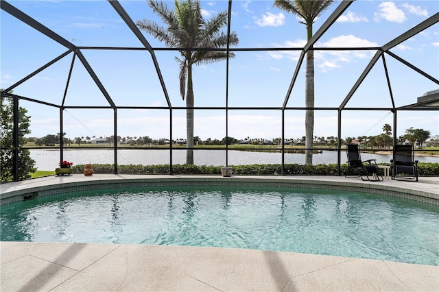 view of pool with a patio, a water view, and glass enclosure