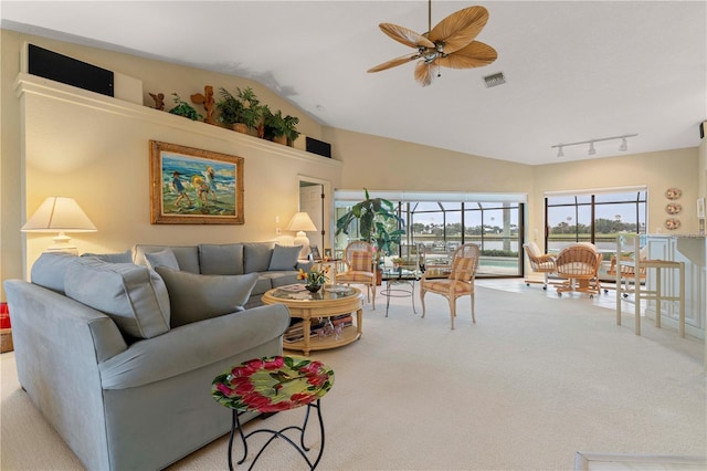 carpeted living room with vaulted ceiling, ceiling fan, and track lighting