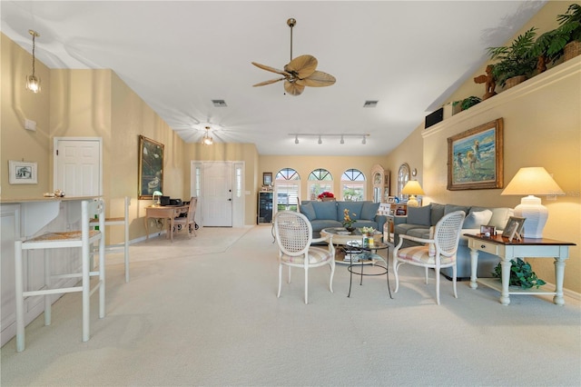 living room with ceiling fan, high vaulted ceiling, and light carpet