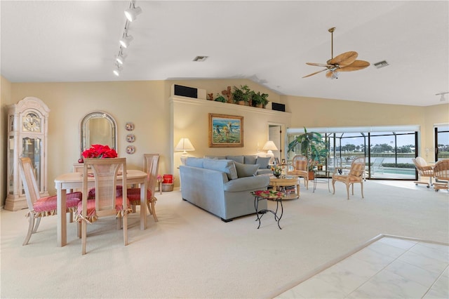 carpeted living room with lofted ceiling, rail lighting, and ceiling fan