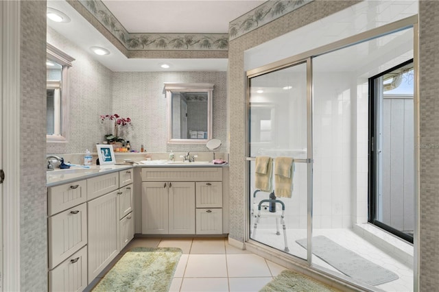 bathroom with walk in shower, vanity, and tile patterned flooring