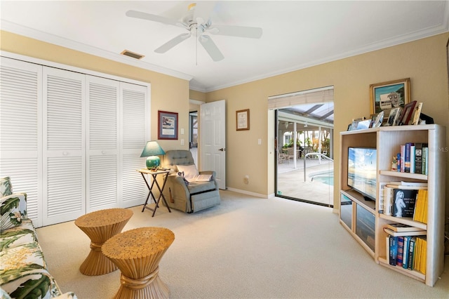 sitting room featuring crown molding, light colored carpet, and ceiling fan