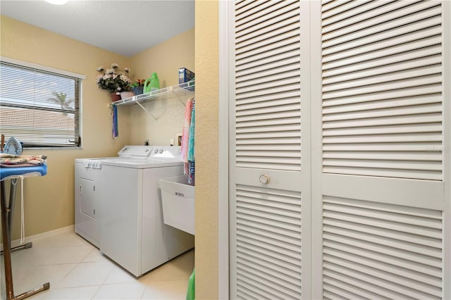 washroom featuring independent washer and dryer and light tile patterned flooring