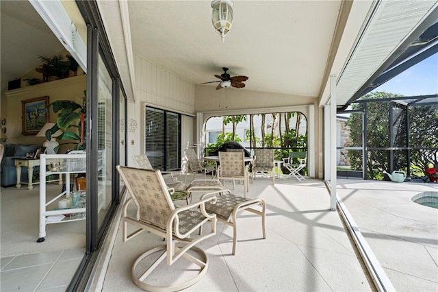 sunroom with ceiling fan and lofted ceiling