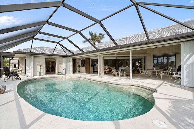 view of swimming pool with a patio area and glass enclosure