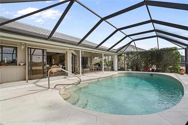 view of pool with a patio area and glass enclosure