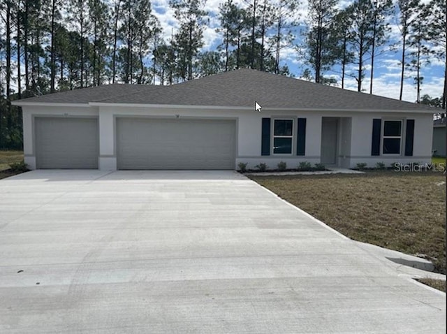 single story home with a garage and a front lawn