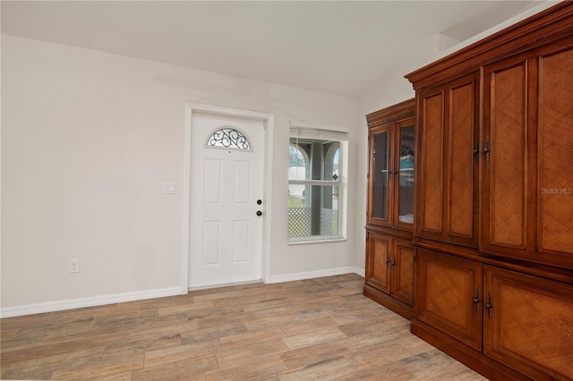 foyer entrance featuring vaulted ceiling