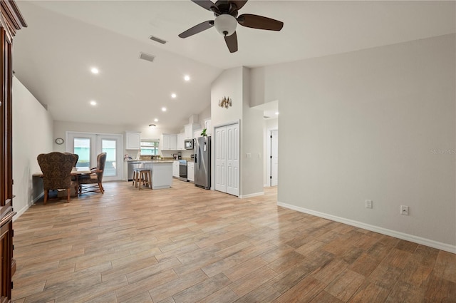 unfurnished living room with vaulted ceiling and ceiling fan