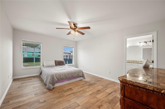 bedroom featuring ensuite bathroom, ceiling fan, and light hardwood / wood-style floors