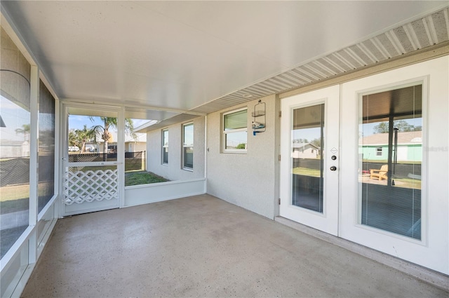 unfurnished sunroom with plenty of natural light and french doors