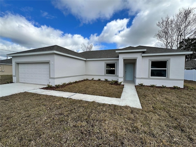 view of front facade with a garage, a front yard, concrete driveway, and stucco siding