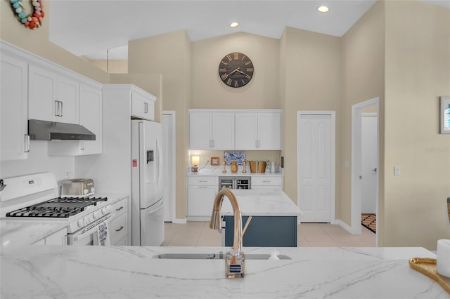 kitchen featuring sink, white cabinetry, white appliances, light stone countertops, and a high ceiling