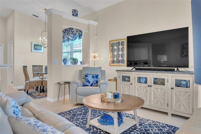 living room with light tile patterned floors and a notable chandelier