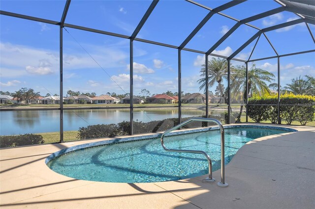 view of pool with a water view, a lanai, and a patio area