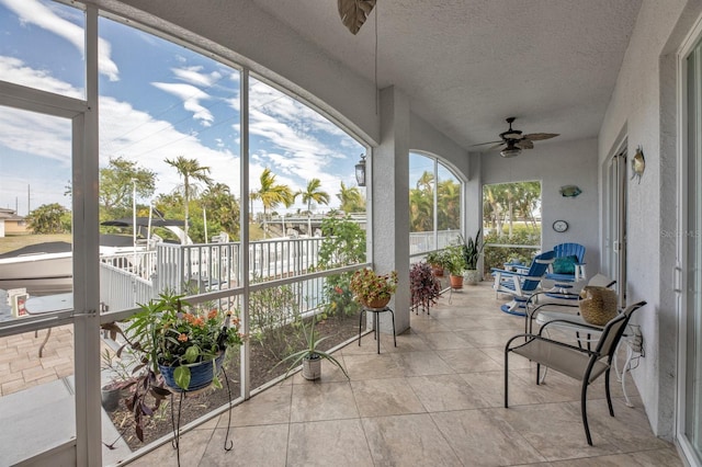 sunroom / solarium featuring ceiling fan