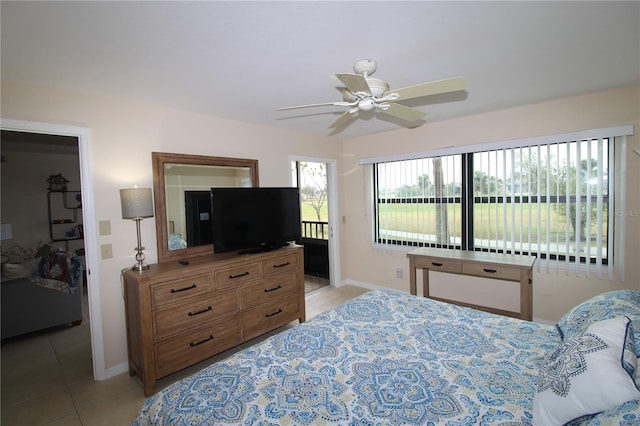 bedroom featuring light tile patterned floors, a closet, and ceiling fan