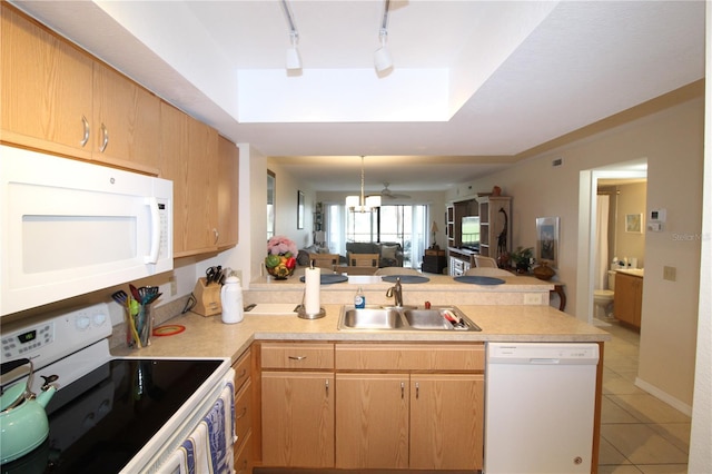 kitchen with light tile patterned flooring, sink, track lighting, kitchen peninsula, and white appliances