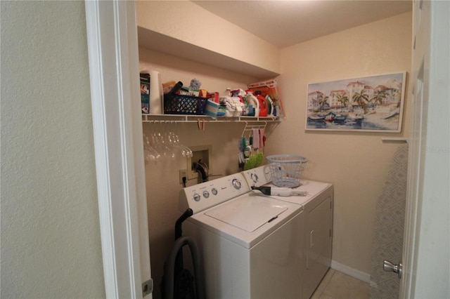 washroom featuring washing machine and clothes dryer and tile patterned floors