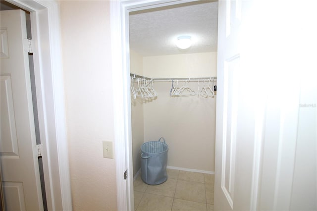 interior space with tile patterned flooring and a textured ceiling