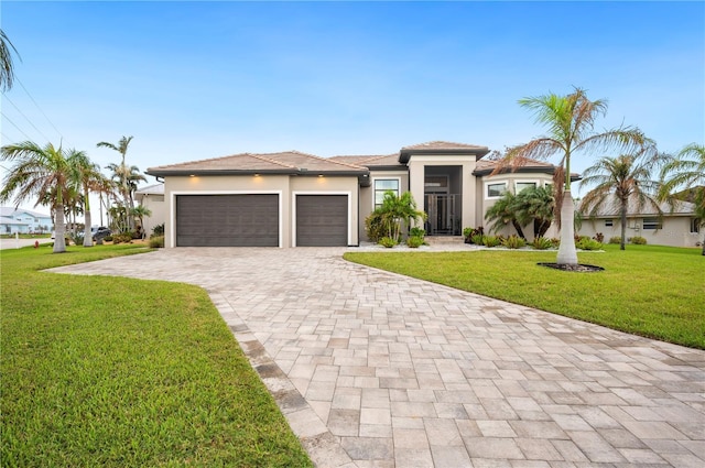 view of front of property featuring a garage and a front yard