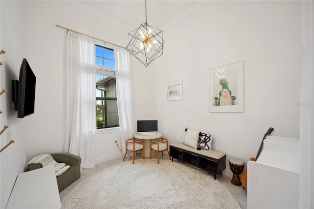 living area with an inviting chandelier and light colored carpet