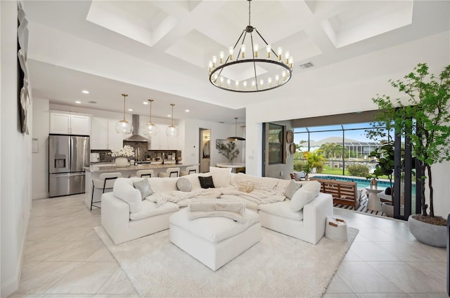 living room featuring light tile patterned floors, beamed ceiling, a chandelier, and coffered ceiling