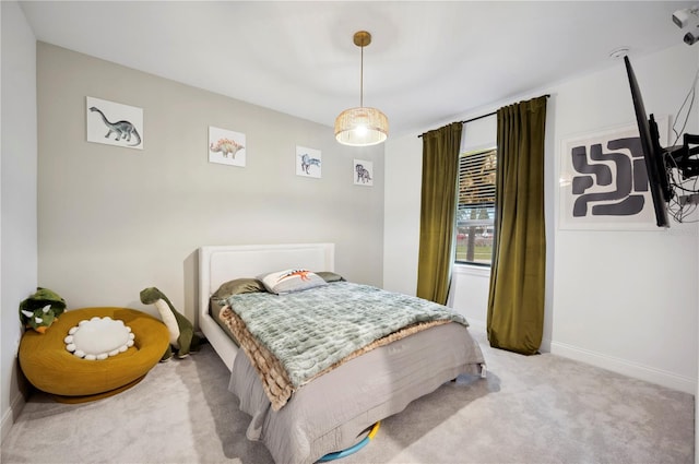 bedroom featuring light carpet