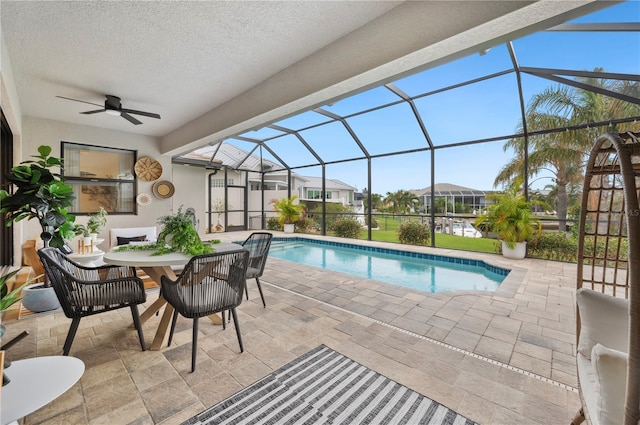 view of swimming pool with a lanai, a patio, and ceiling fan