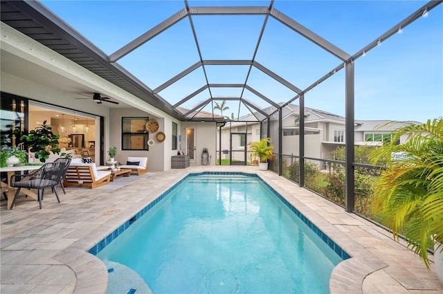 view of pool featuring a lanai, a patio area, outdoor lounge area, and ceiling fan