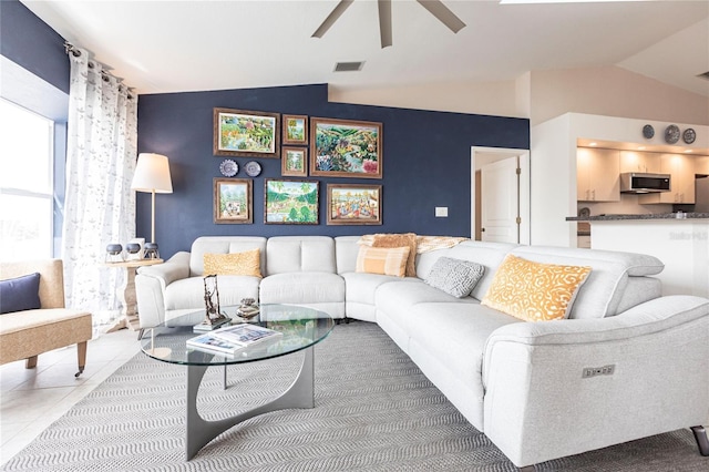 tiled living room with vaulted ceiling and ceiling fan