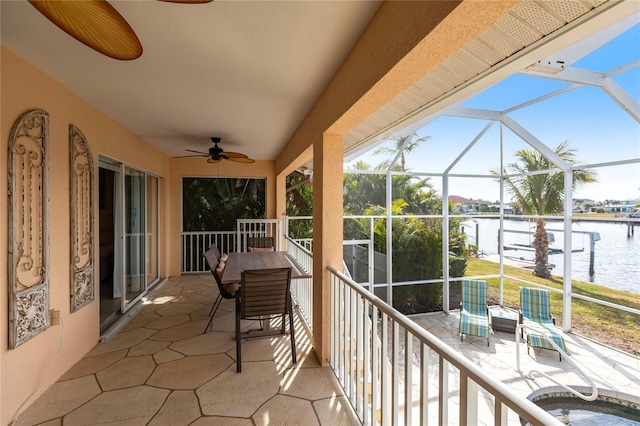 exterior space featuring a patio, a water view, and ceiling fan