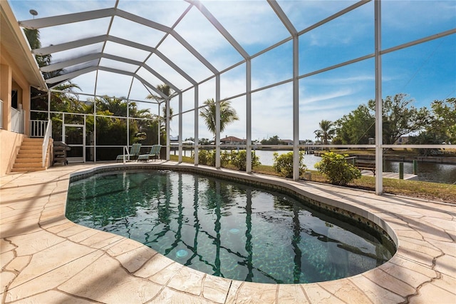 view of swimming pool featuring a water view, a lanai, and a patio area