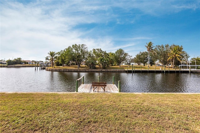 dock area with a water view and a lawn