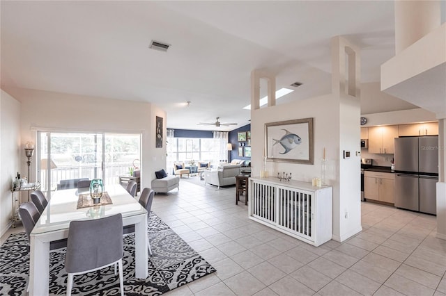 dining space with light tile patterned flooring and ceiling fan