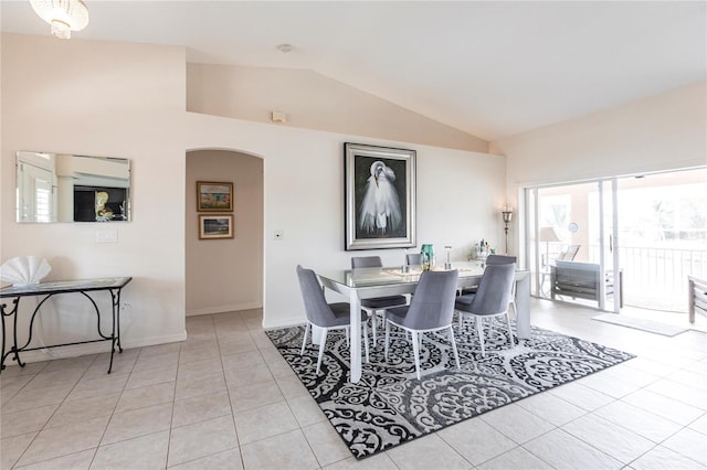 tiled dining space with lofted ceiling