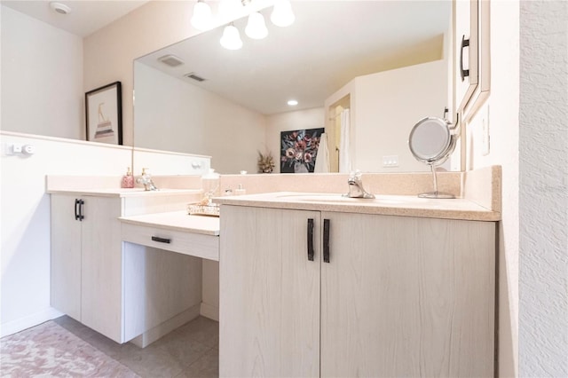 bathroom with tile patterned floors and vanity