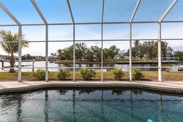 view of swimming pool with a water view and a lanai